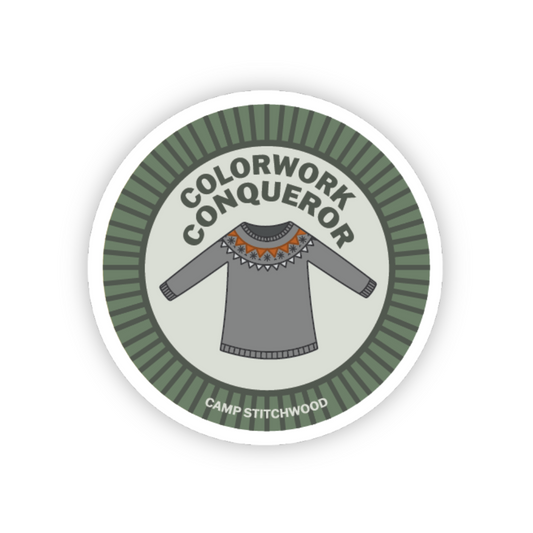 Sticker with a sweater design and text 'Colorwork Conqueror' on a white background