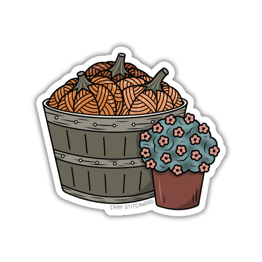 Sticker with yarn ball pumpkins in a basket and a small pot of flowers