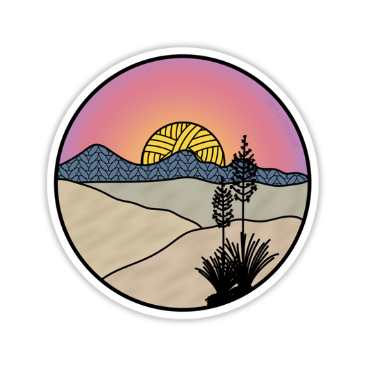 Round sticker with a desert landscape design featuring a sunset, mountains, and cacti.