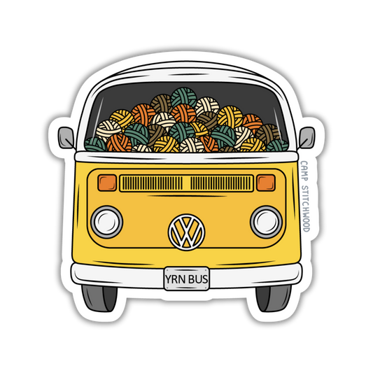 A die-cut vinyl sticker featuring a retro yellow Volkswagen Type I bus filled with colorful knitted yarn balls, shown on a plain white background.