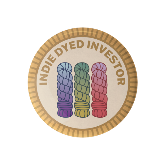 Circular badge with text 'Indie Dyed Investor' and images of three skeins of yarn in blue, green, and red on a beige background.