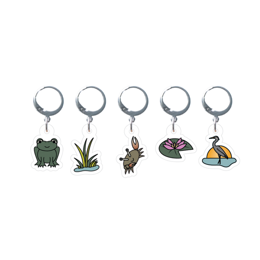 Set of five stitch markes with frog, grass, crab, lily pad, and heron designs on a white background.