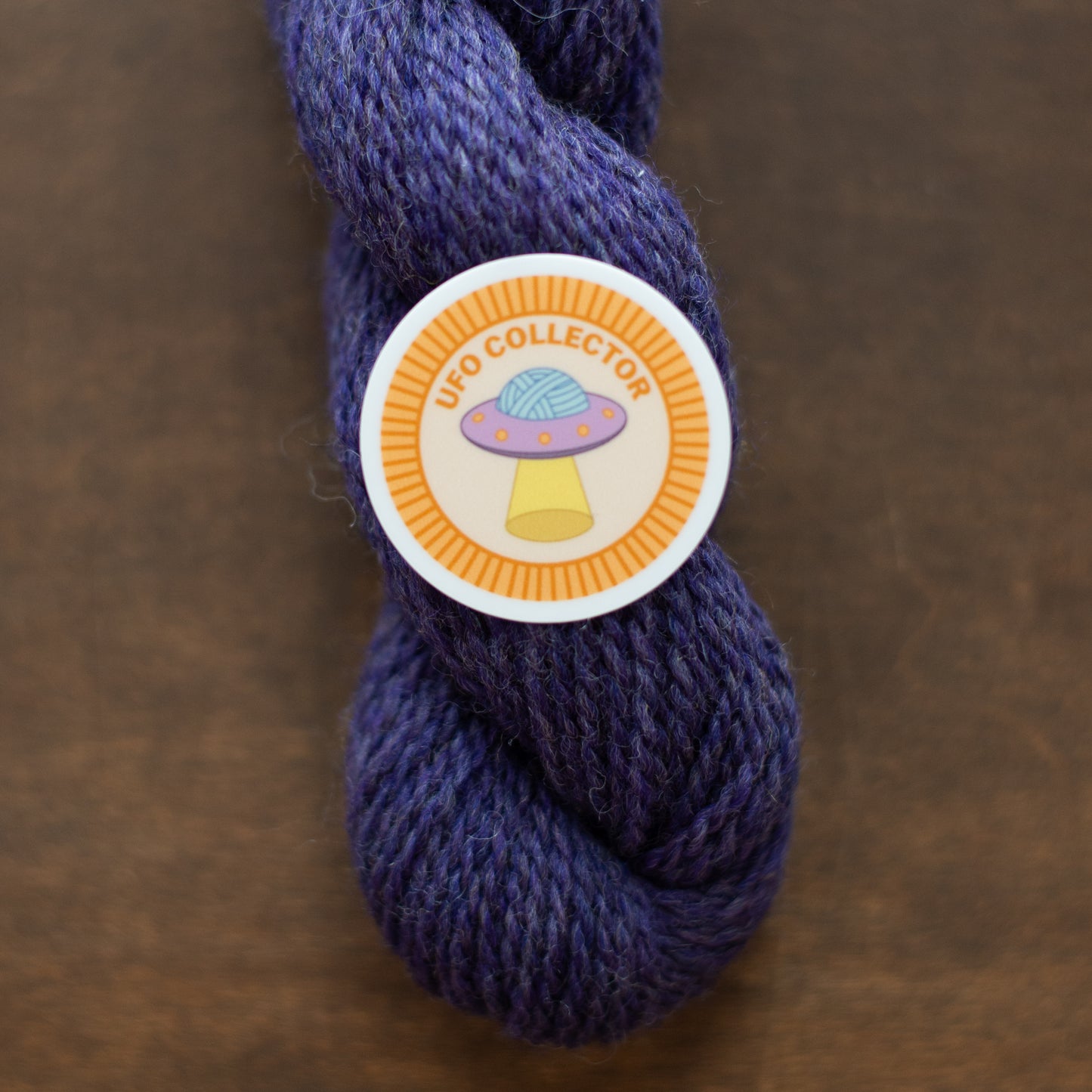 UFO Collector Sticker on Purple Yarn