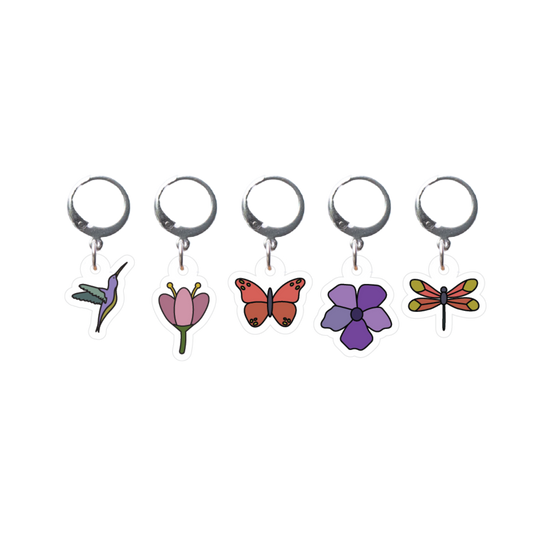 Set of five stitch markers with colorful insect and flower designs on a white background