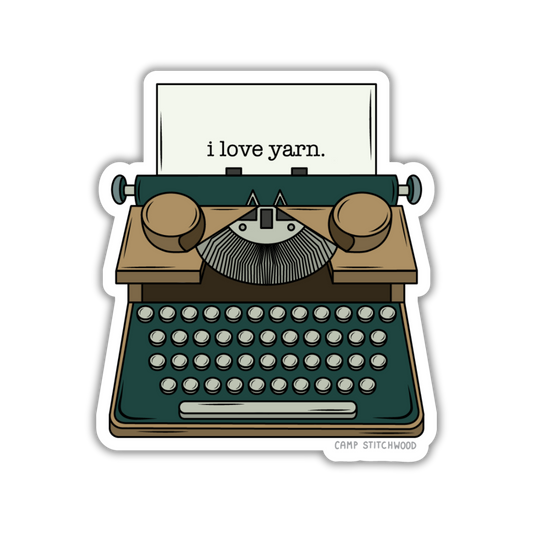 Sticker of a typewriter with 'i love yarn' text on a white background