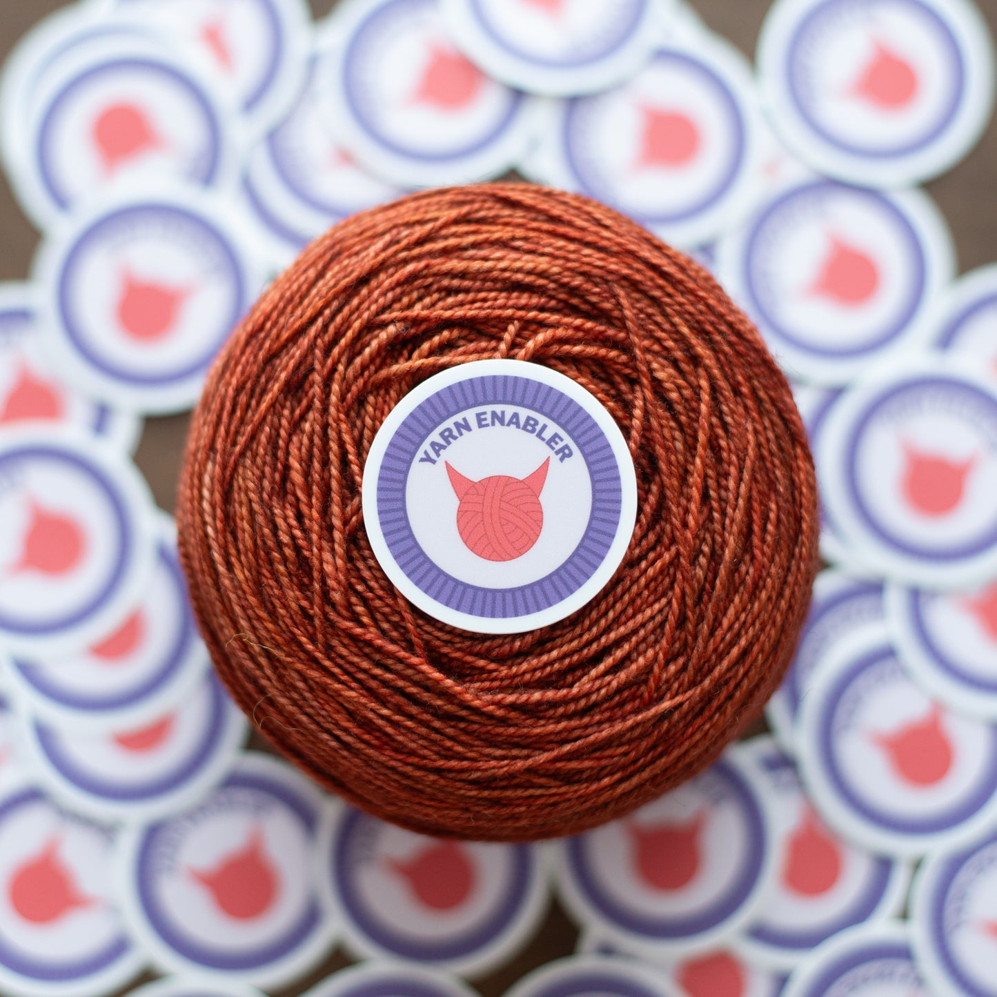 Yarn Enabler Sticker on a cake of yarn