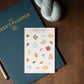 Sticker sheet with fall-themed illustrations on a blue planner