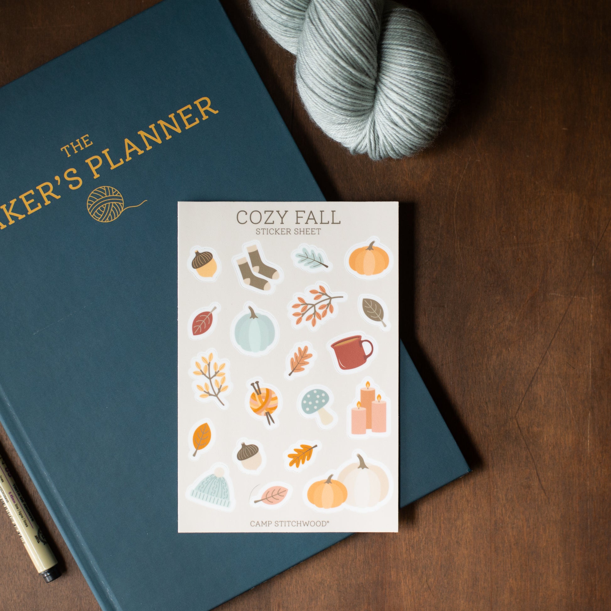 Sticker sheet with fall-themed illustrations on a blue planner