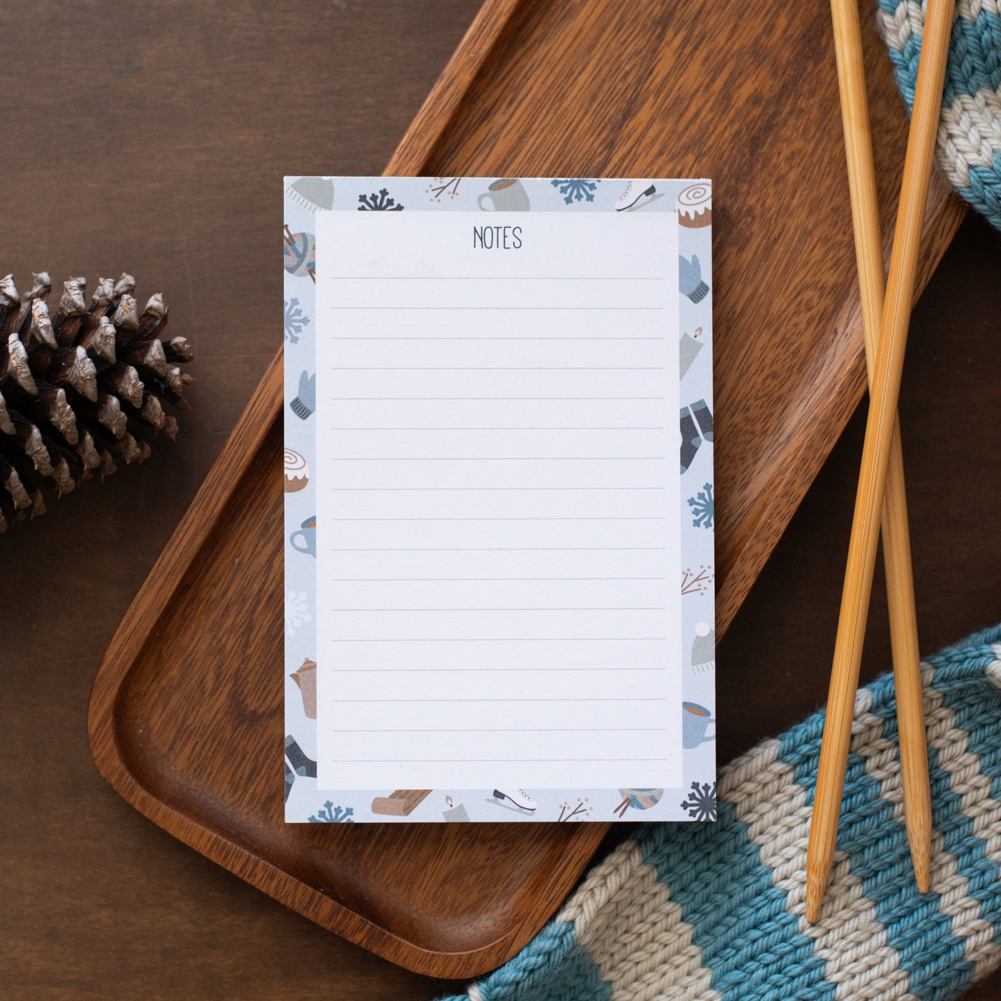Notepad with snowflake design on a wooden tray