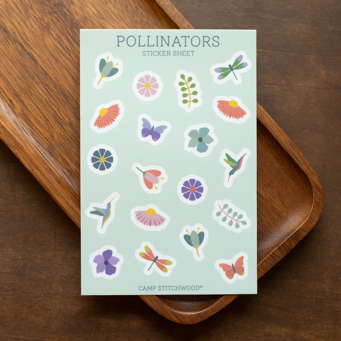 Sheet of 'Pollinators' stickers on a wooden surface