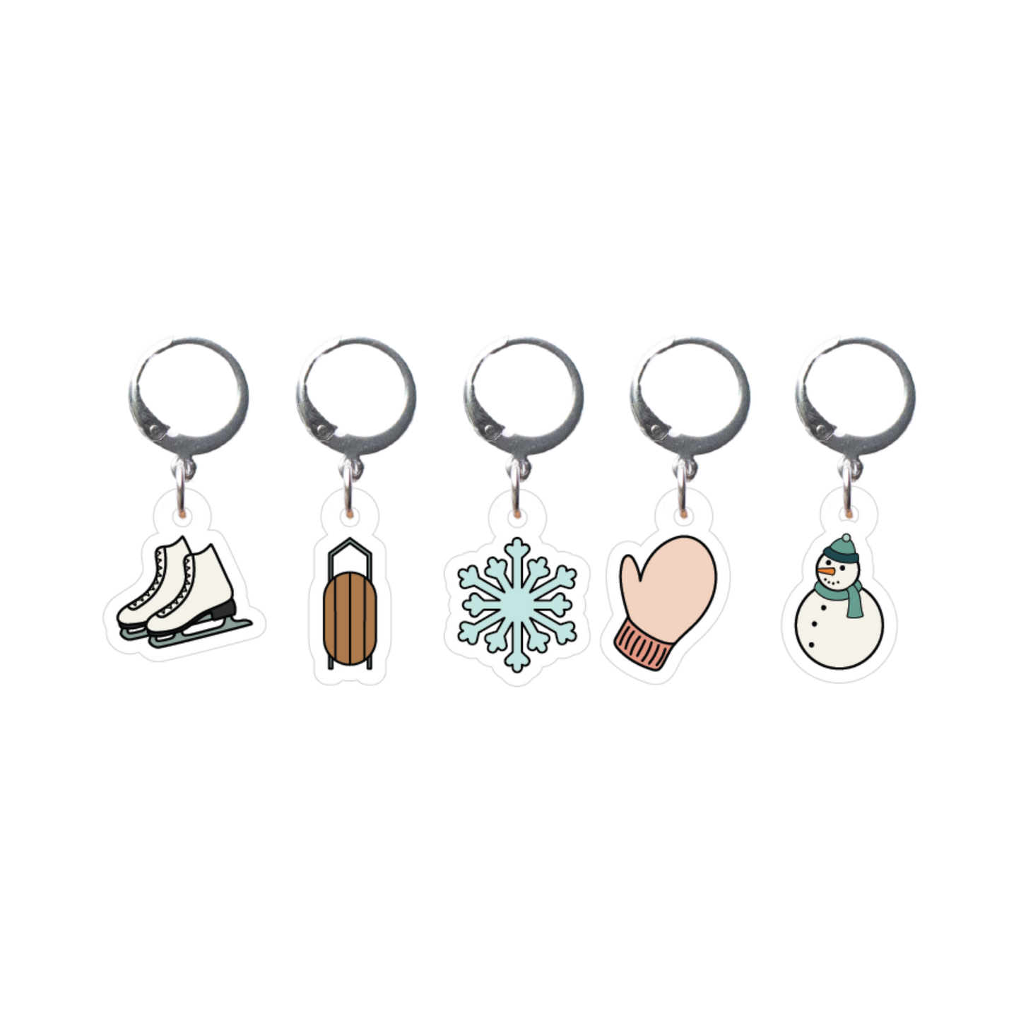Set of five winter-themed stitch markers on a white background