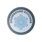 Circular merit badge with a snowflake and 'Snowbound Stitcher' text on a white background