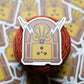 Sticker of a vintage radio on a cake of yarn with more stickers in the background.