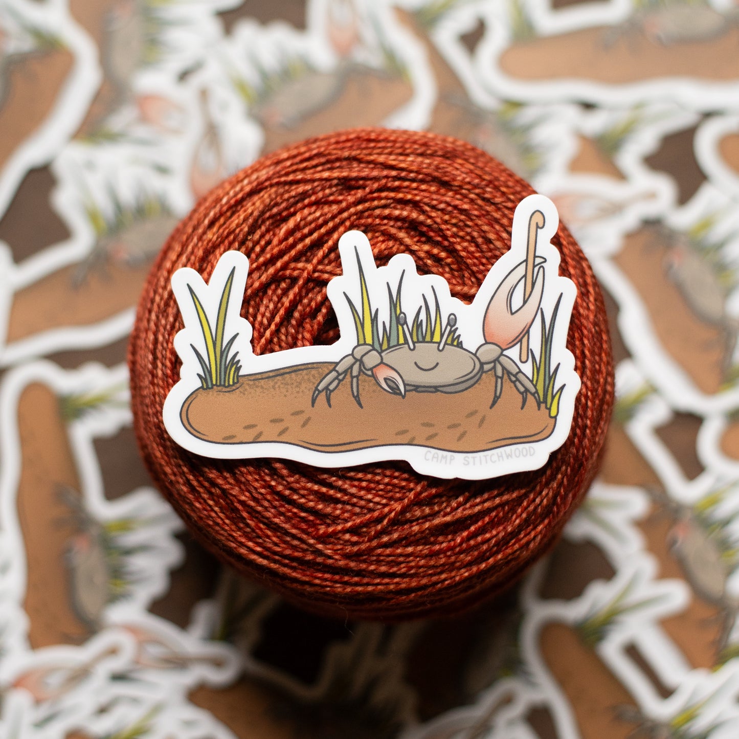 Yarn ball with a crab sticker on a patterned background