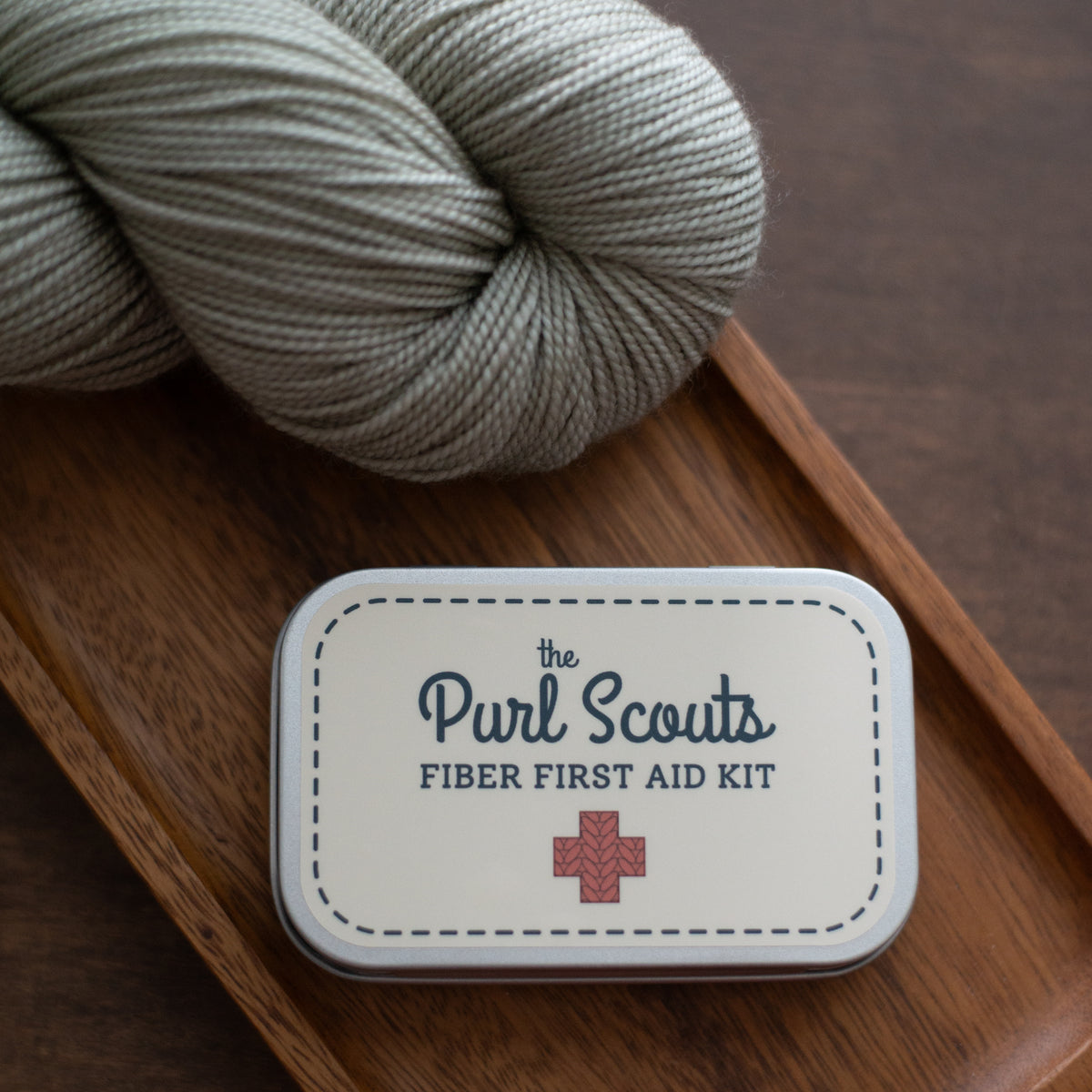 The fiber first aid kit on a table with yarn