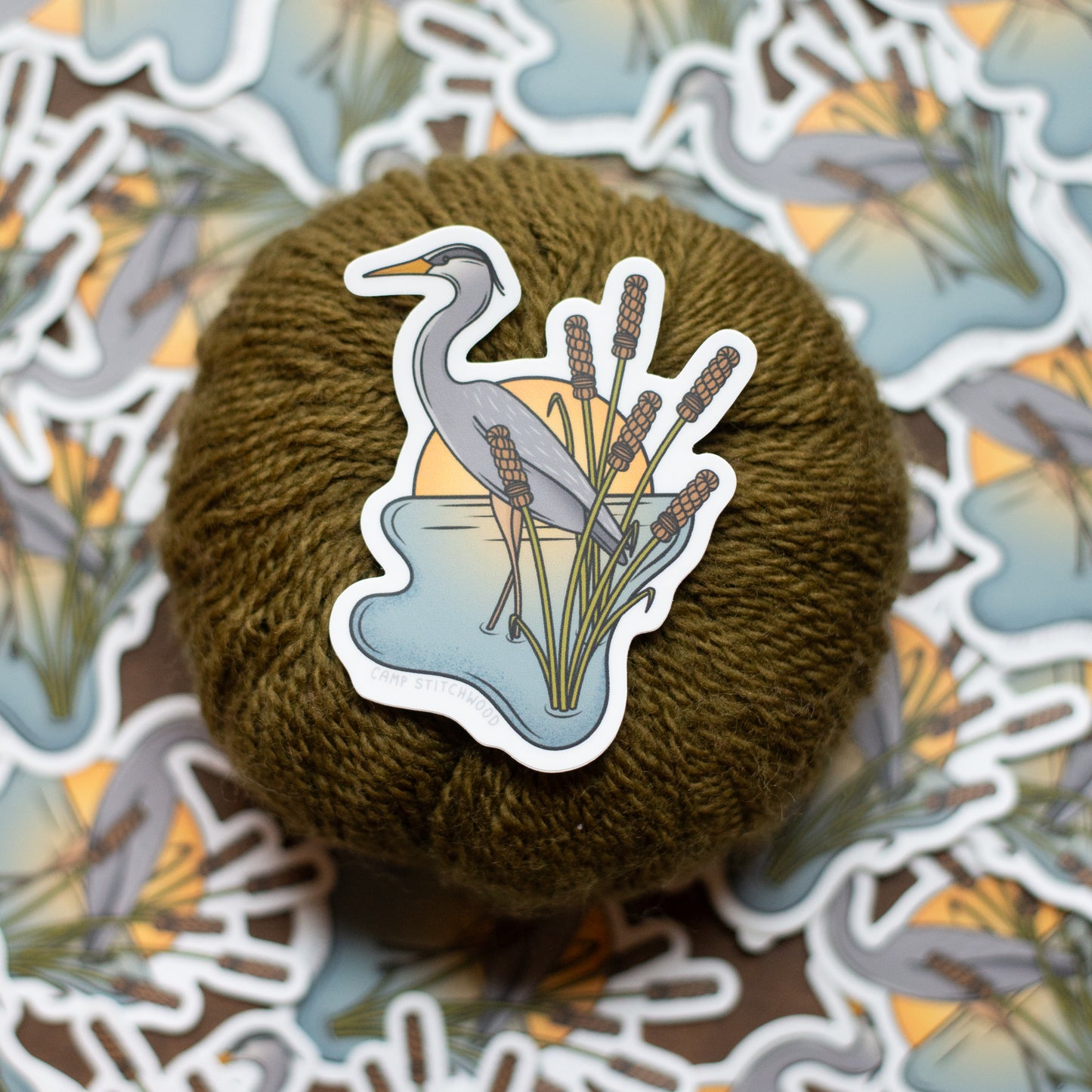 Yarn ball with a heron sticker on a patterned background