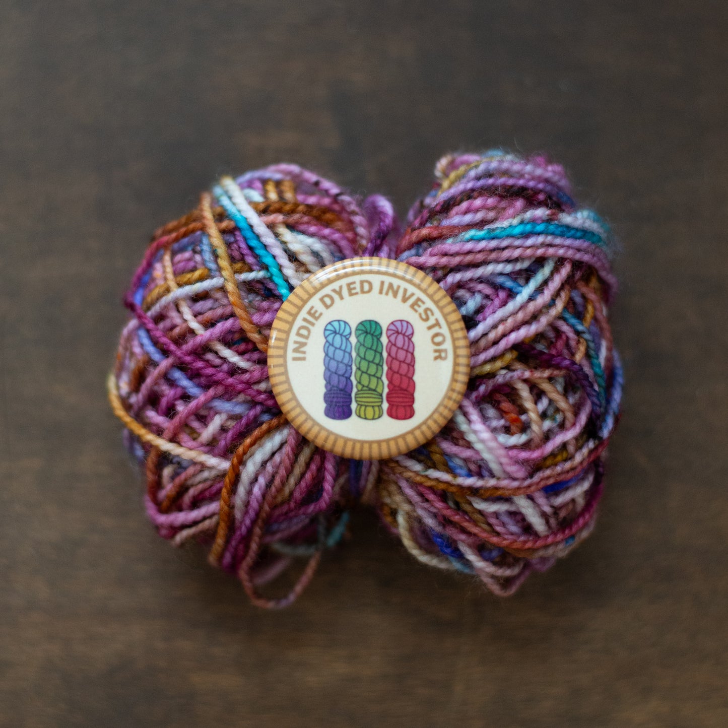 Indie Dyed Investor badge on multicolor yarn