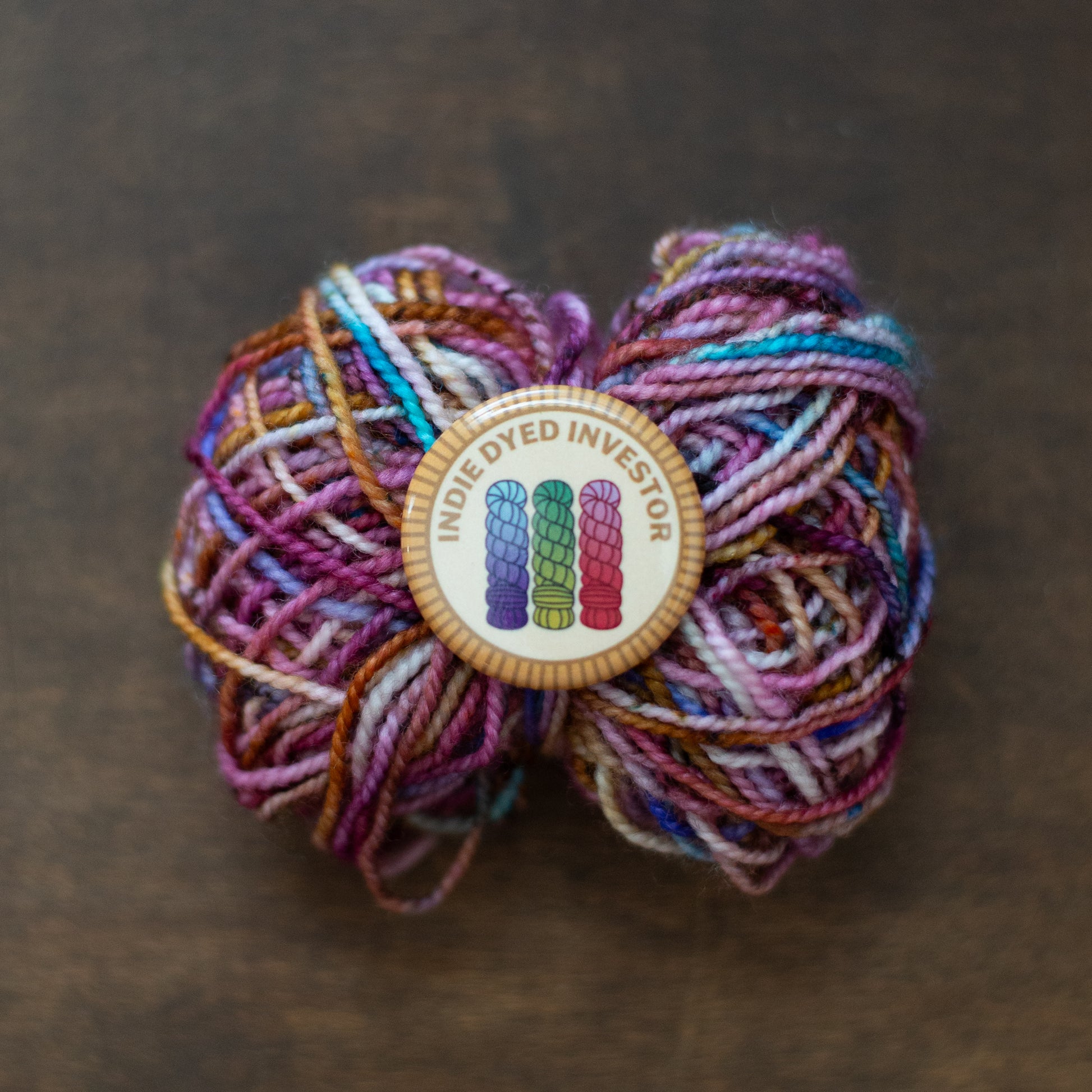Indie Dyed Investor badge on multicolor yarn