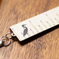 Clip on tool  with bird design on a wooden surface