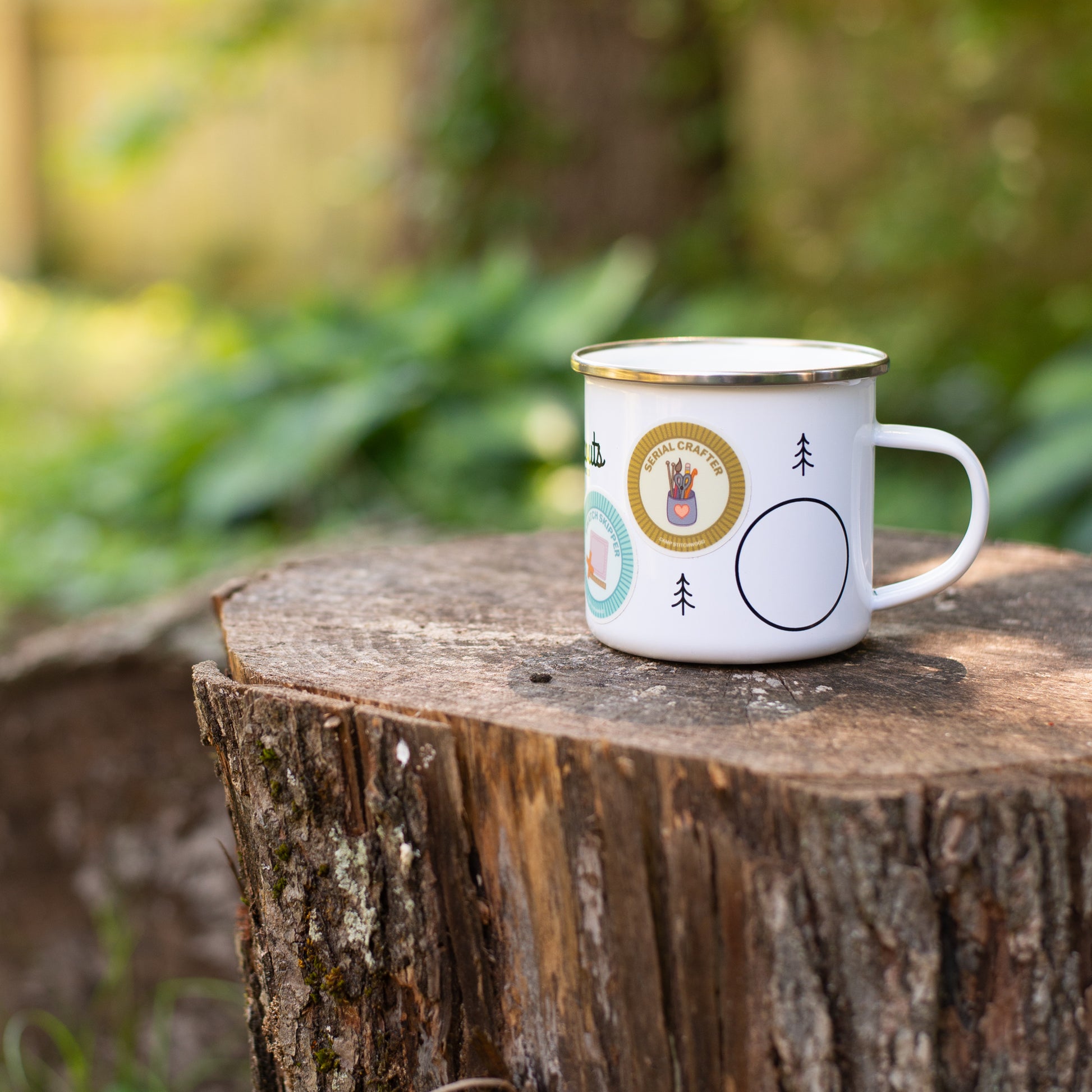 The Purl Scouts Camp Mug outside on a log