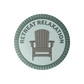 Circular logo with a wooden chair and 'Retreat Relaxation' text on a light blue background