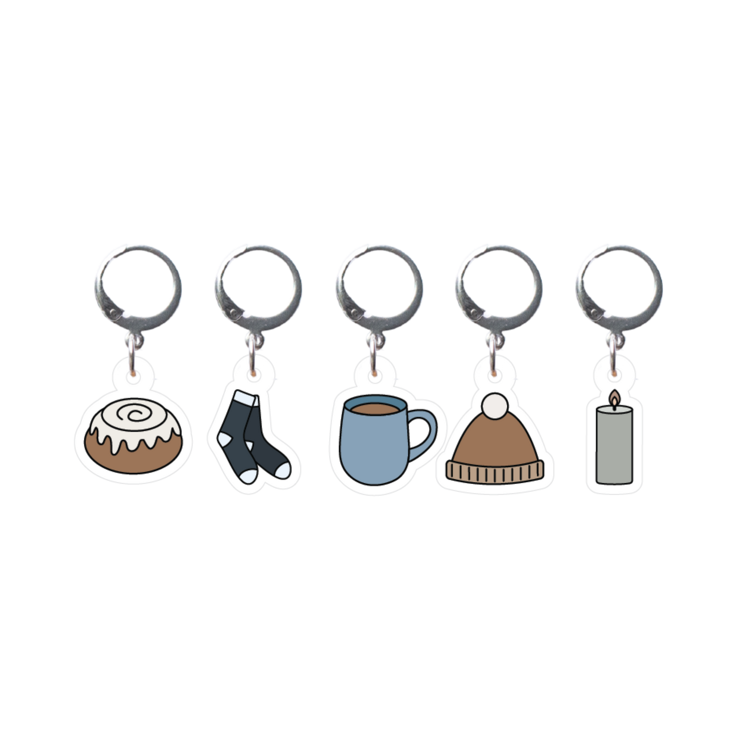 Set of five stitch markers with different charms on a white background