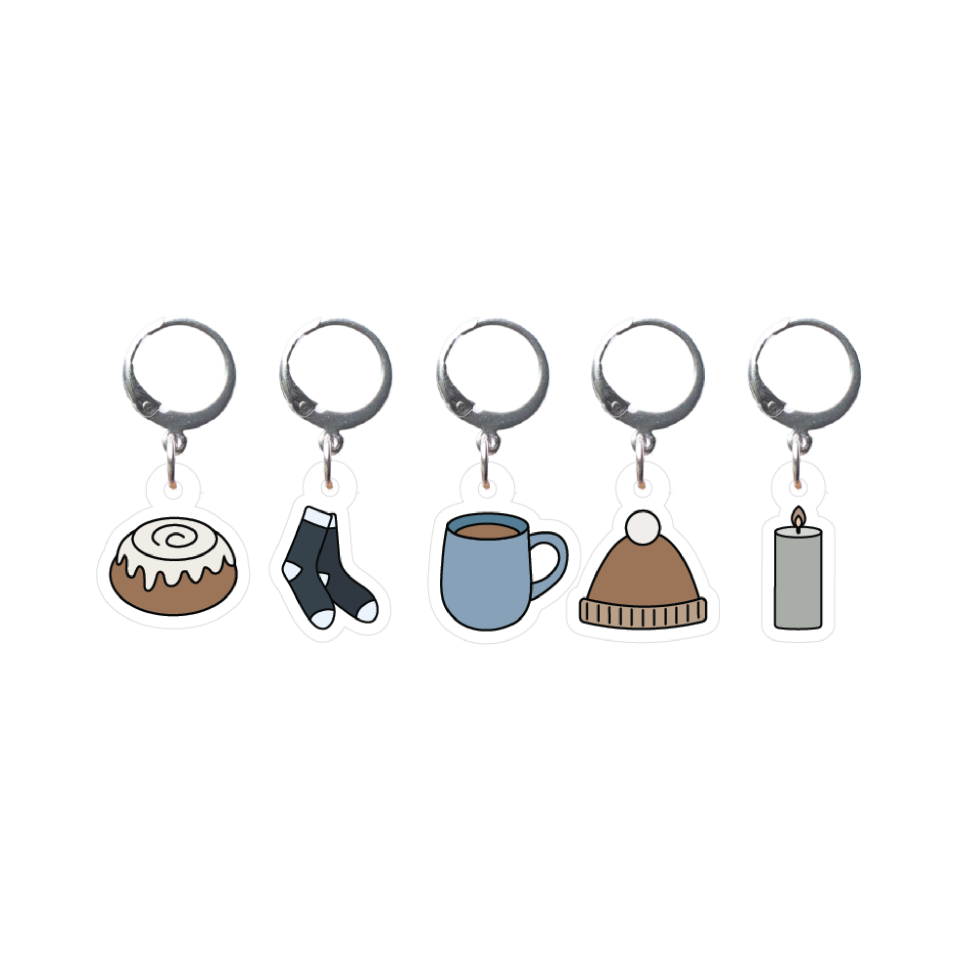 Set of five stitch markers with different charms on a white background