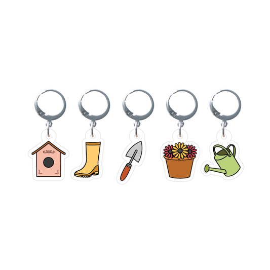 Set of five garden-themed stitch markers on a white background