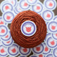 Yarn Enabler Sticker on a cake of yarn