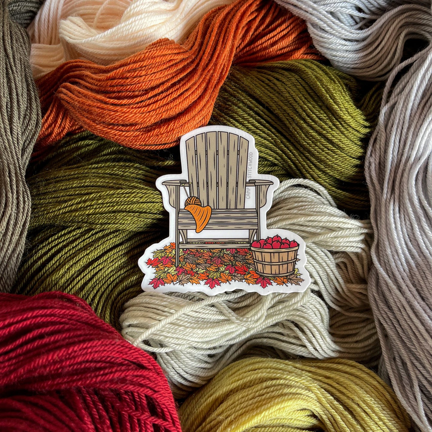  sticker of an adirondack chair on fall toned yarn