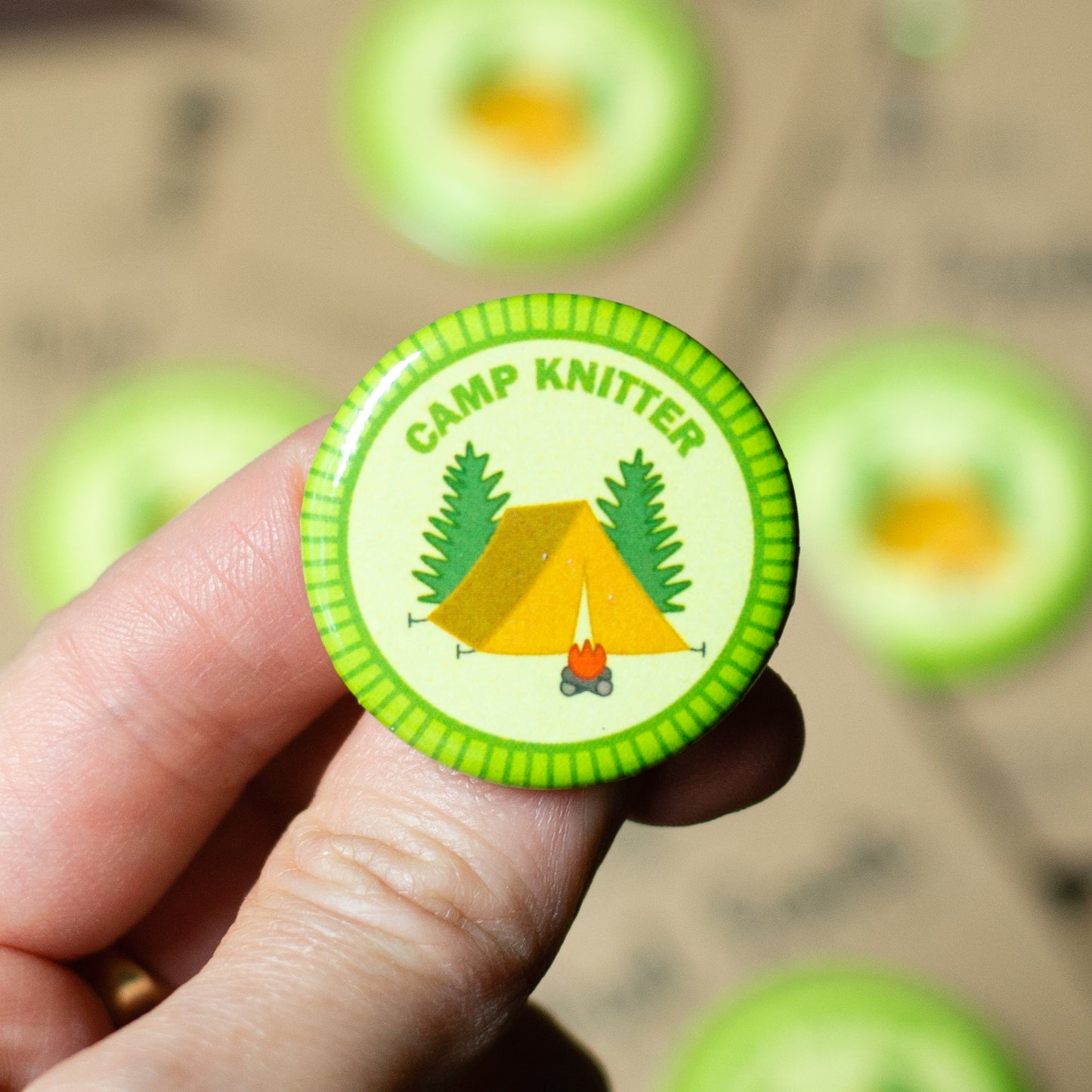 camp knitter  pin, knitting pin-back merit badge by adKnits